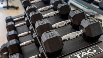 A rack of dumbbells with weights marked from 5 to 20 kilograms.