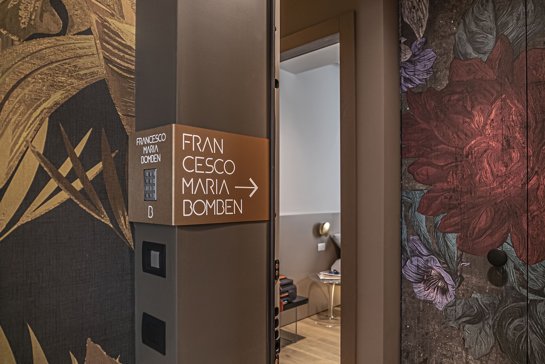 L’intérieur d’un hôtel, avec une pancarte indiquant le numéro de la chambre, la chambre 3, qui porte le nom de « Francesco Maria Domden ».