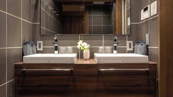 A modern bathroom with two sinks, a large mirror, and a wooden ceiling.
