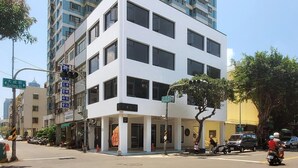 A modern multi-story building with a white facade and large windows. - Little Inn (Kaohsiung)