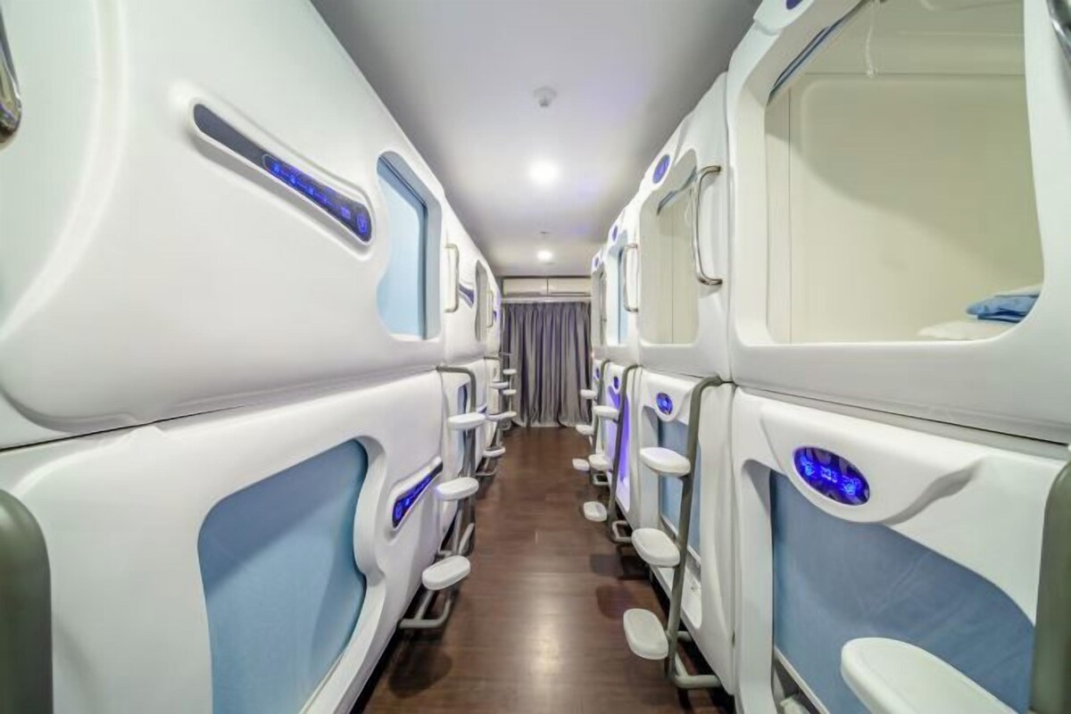 A row of private cabins with individual seating areas, each equipped with a control panel and a small window.