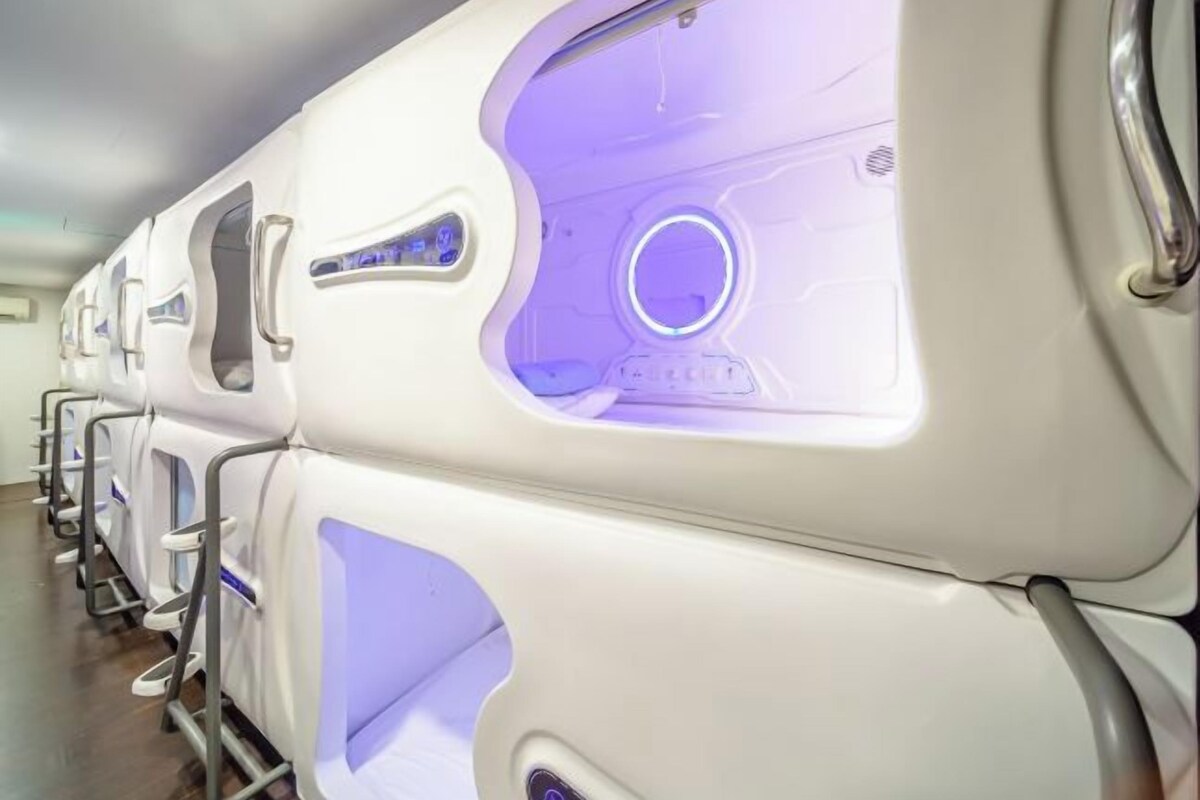 A row of massage chairs with a circular light feature.