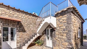 A stone building with a staircase leading to a balcony. - Villa Giulia: Views, Pool & Concierge by Feeling Italy (Sorrento)