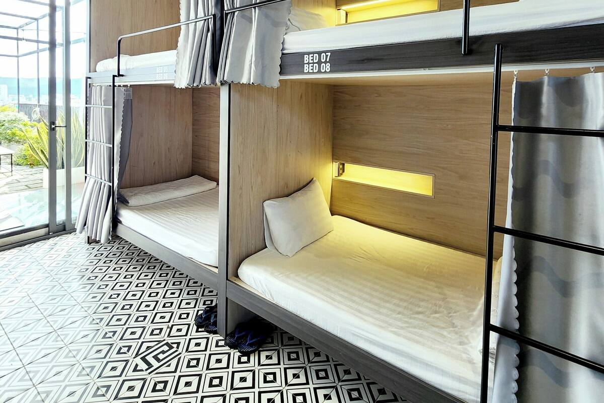 A bunk bed room with a view of the outdoors.