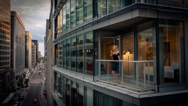 A modern hotel with a glass balcony, a view of the city street, and a well-lit interior. - reStays Ottawa (Ottawa)