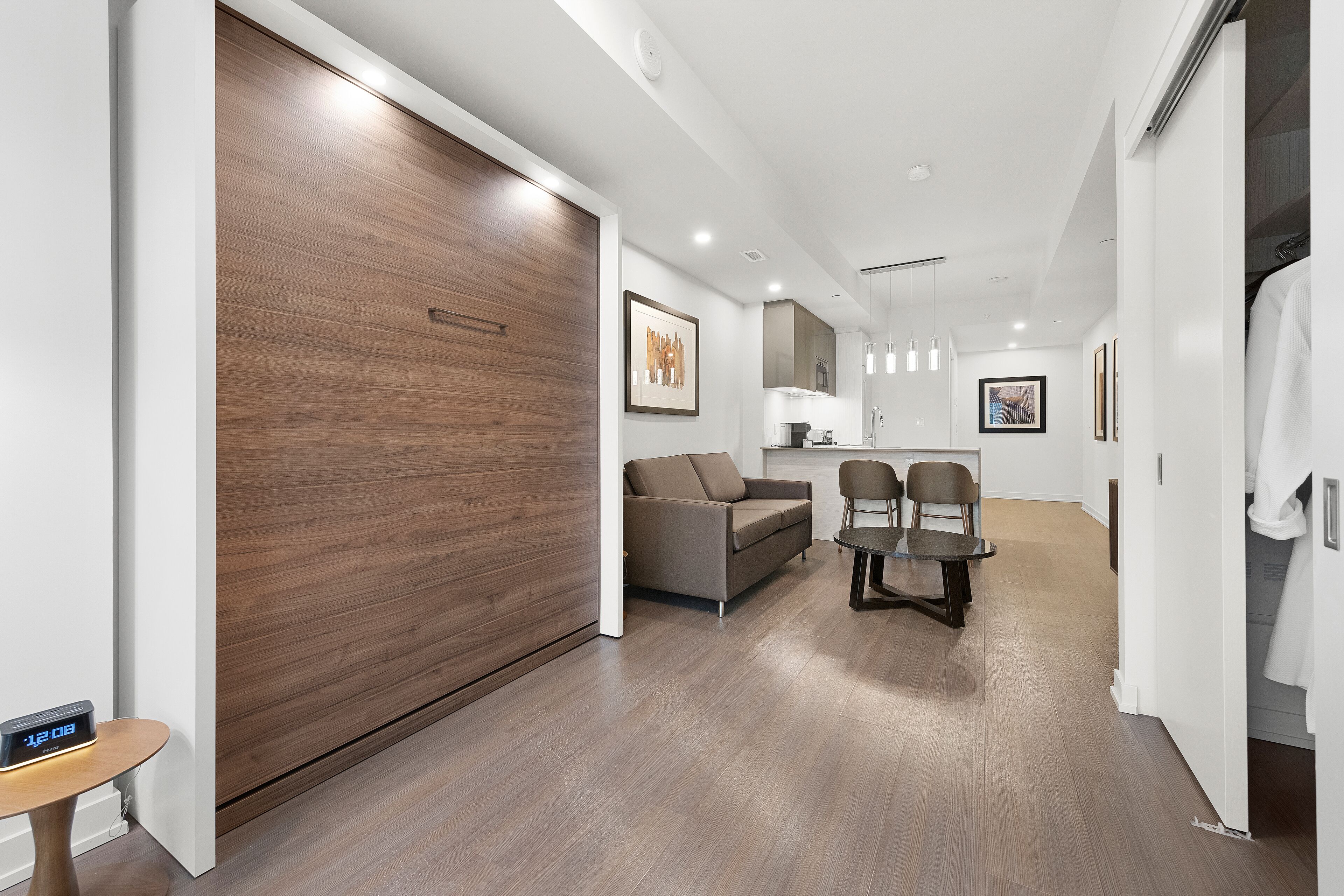 A modern living room with a sofa, chairs, a coffee table, and a wooden sliding door.