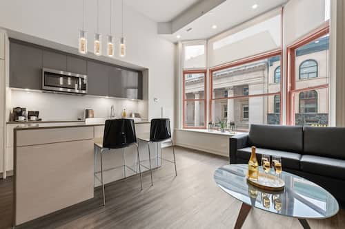 City Loft | Living area | 55-inch TV with satellite channels, streaming services