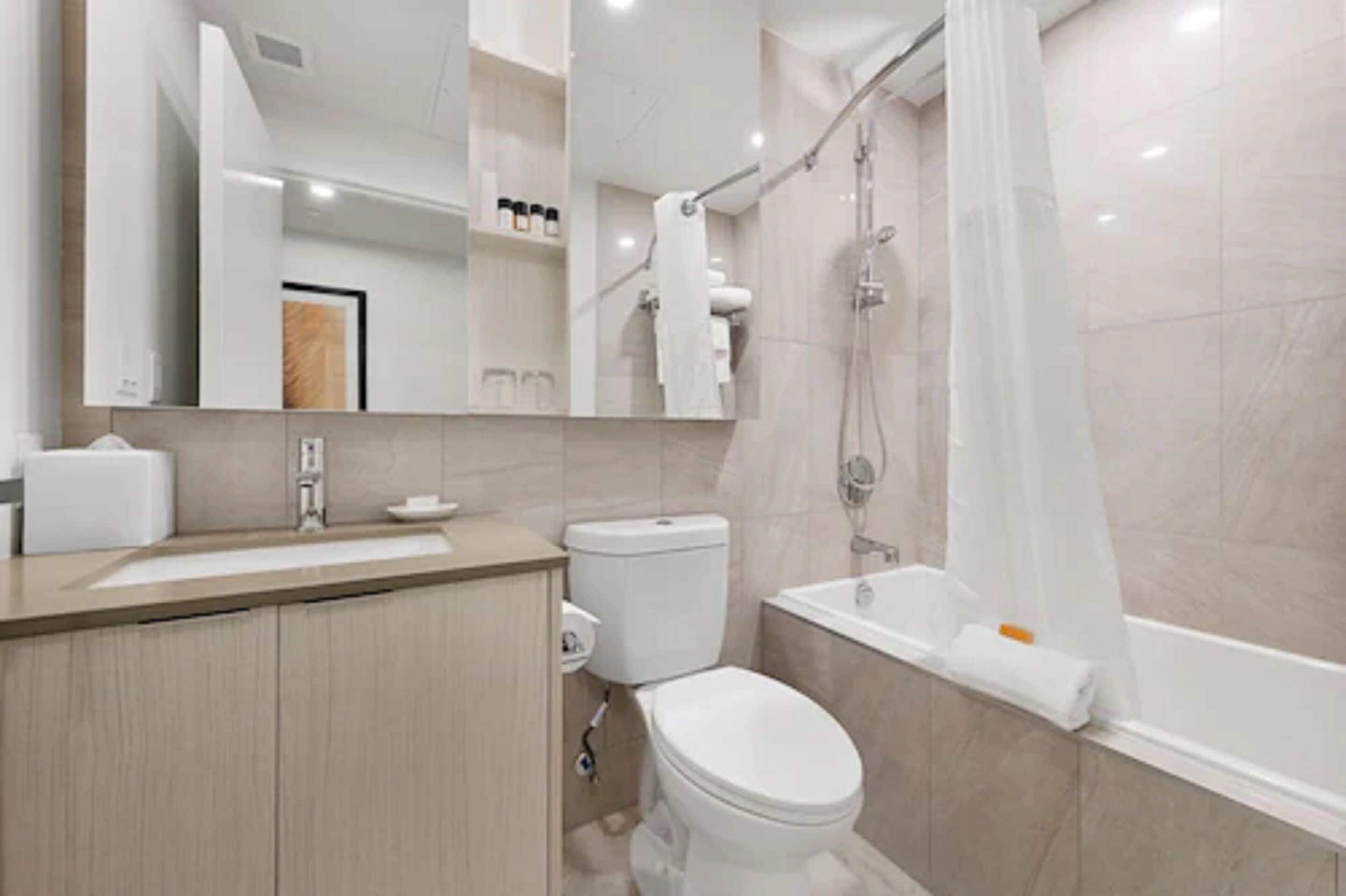 city condo, 2 bedrooms | bathroom | combined shower/bathtub, rainfall showerhead, designer toiletries