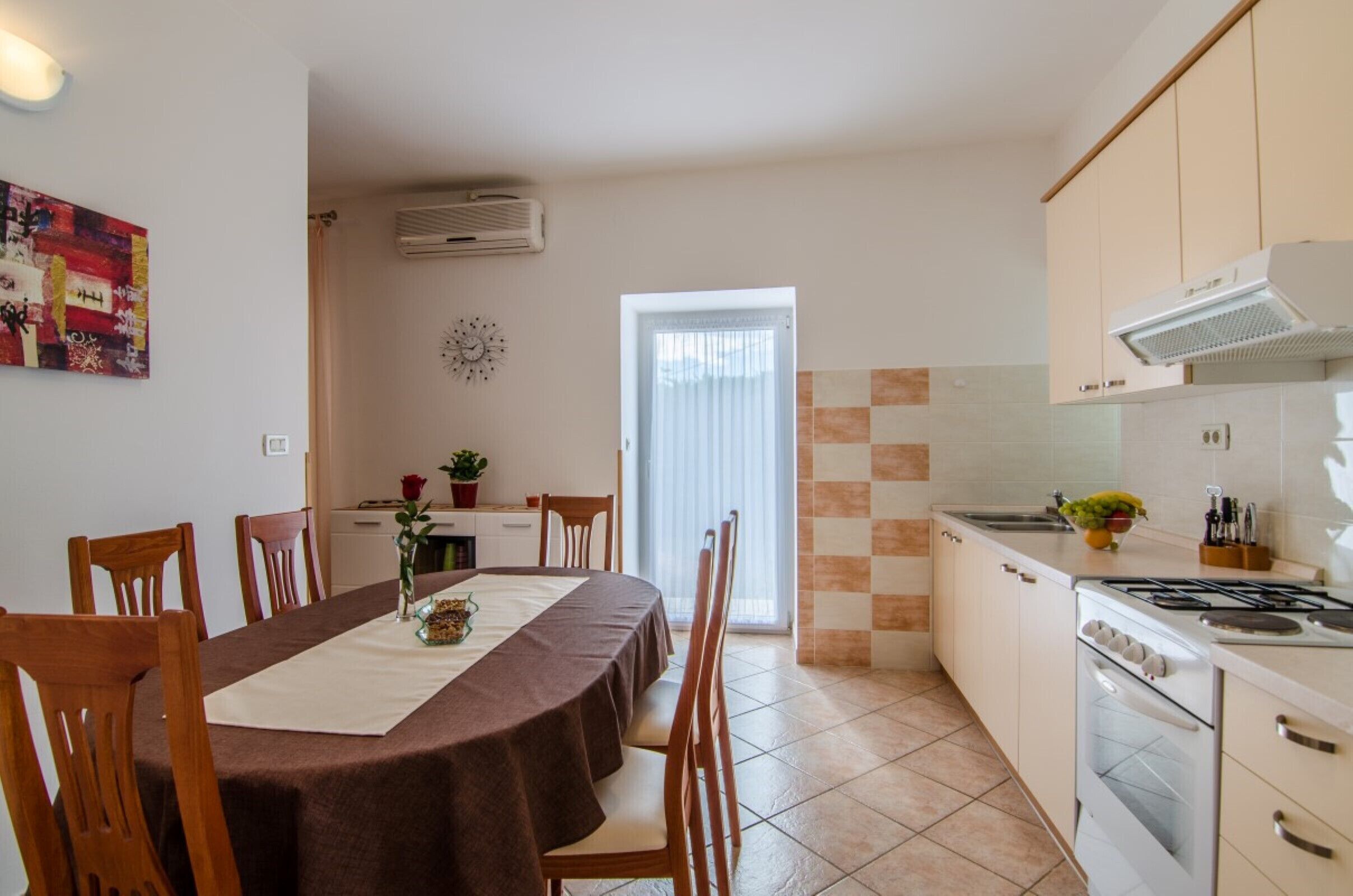 Een koelkast, een oven, een waterkoker, kookgerei, borden en bestek