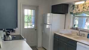 A kitchen with a refrigerator, stove, sink, and cabinets. - Beautiful Indian Lake with canal leading to Crystal River and the Ocean. (Crystal River)