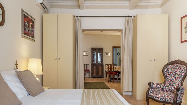 A bedroom with a bed, a chair, a desk, and a wardrobe. - Fontanella Borghese (Rome)