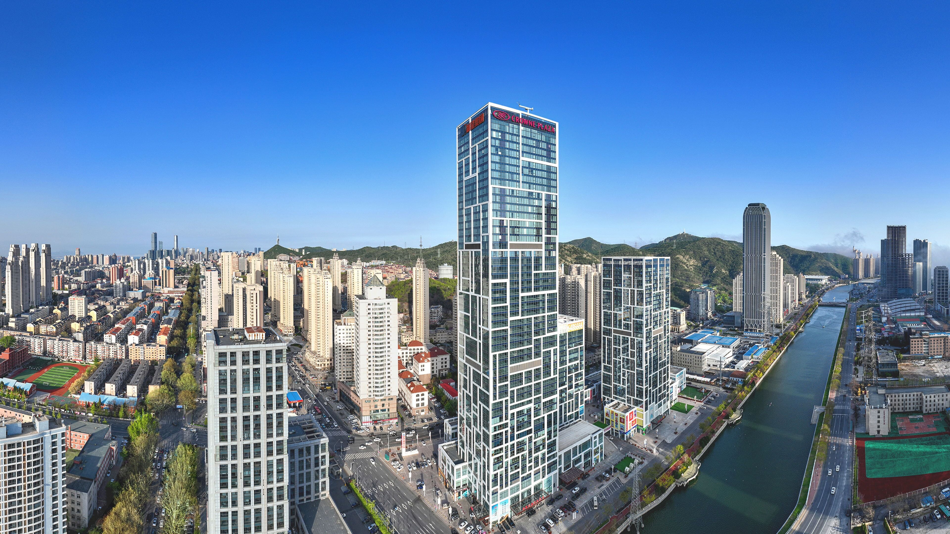 A high-rise building with a prominent sign at the top.