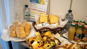 A buffet table with various food items, including bread, pastries, and condiments. - Home Josèphine (Caserta)