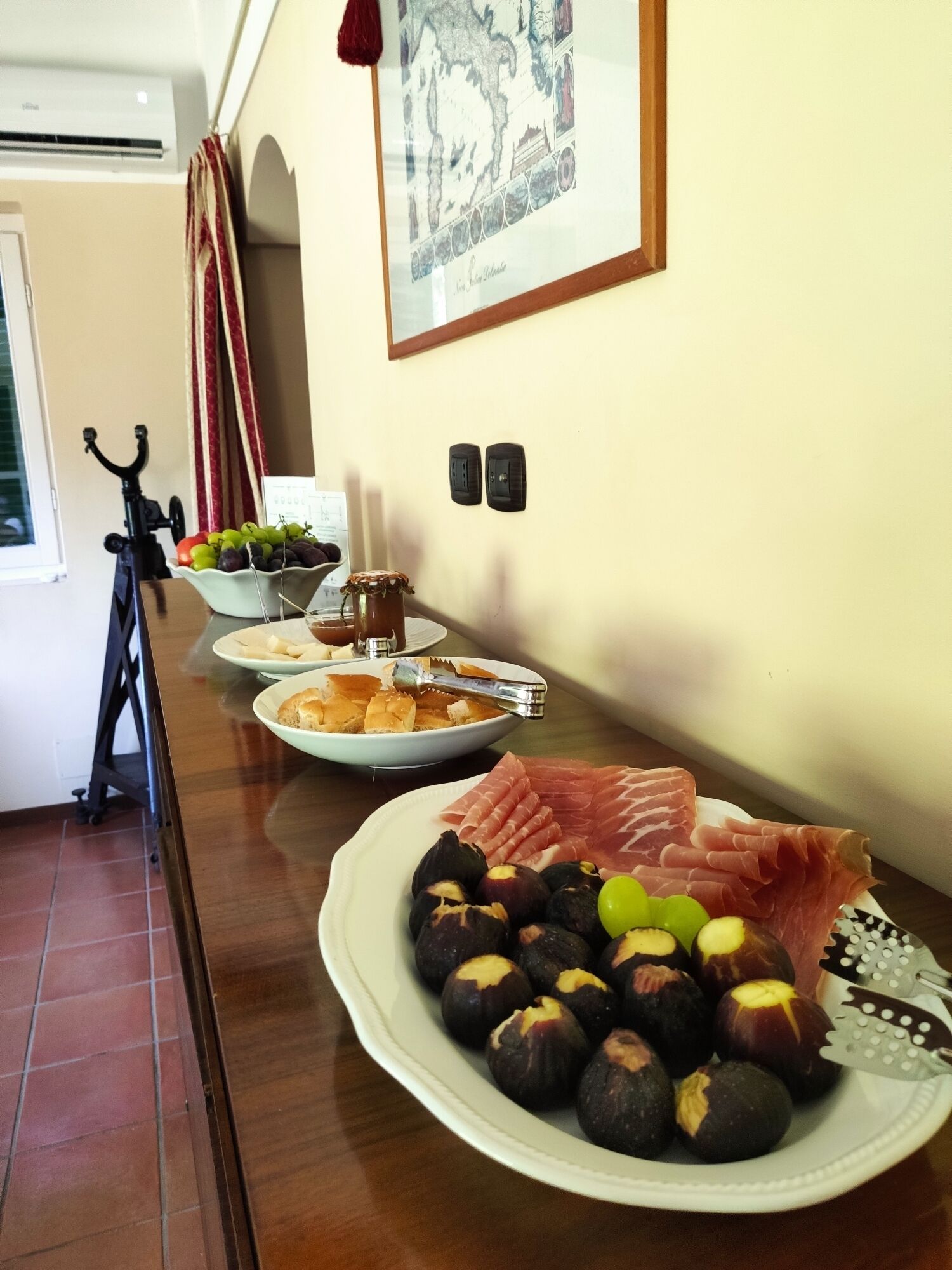 A dining table with plates of food, a bicycle, and a wall-mounted air conditioner.