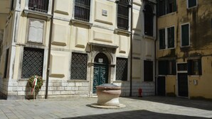 A historic building with a central entrance, large windows, and a decorative facade.