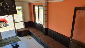 A corner seating area with a bench and a door leading outside. - Hotel Atlantico (Veracruz)