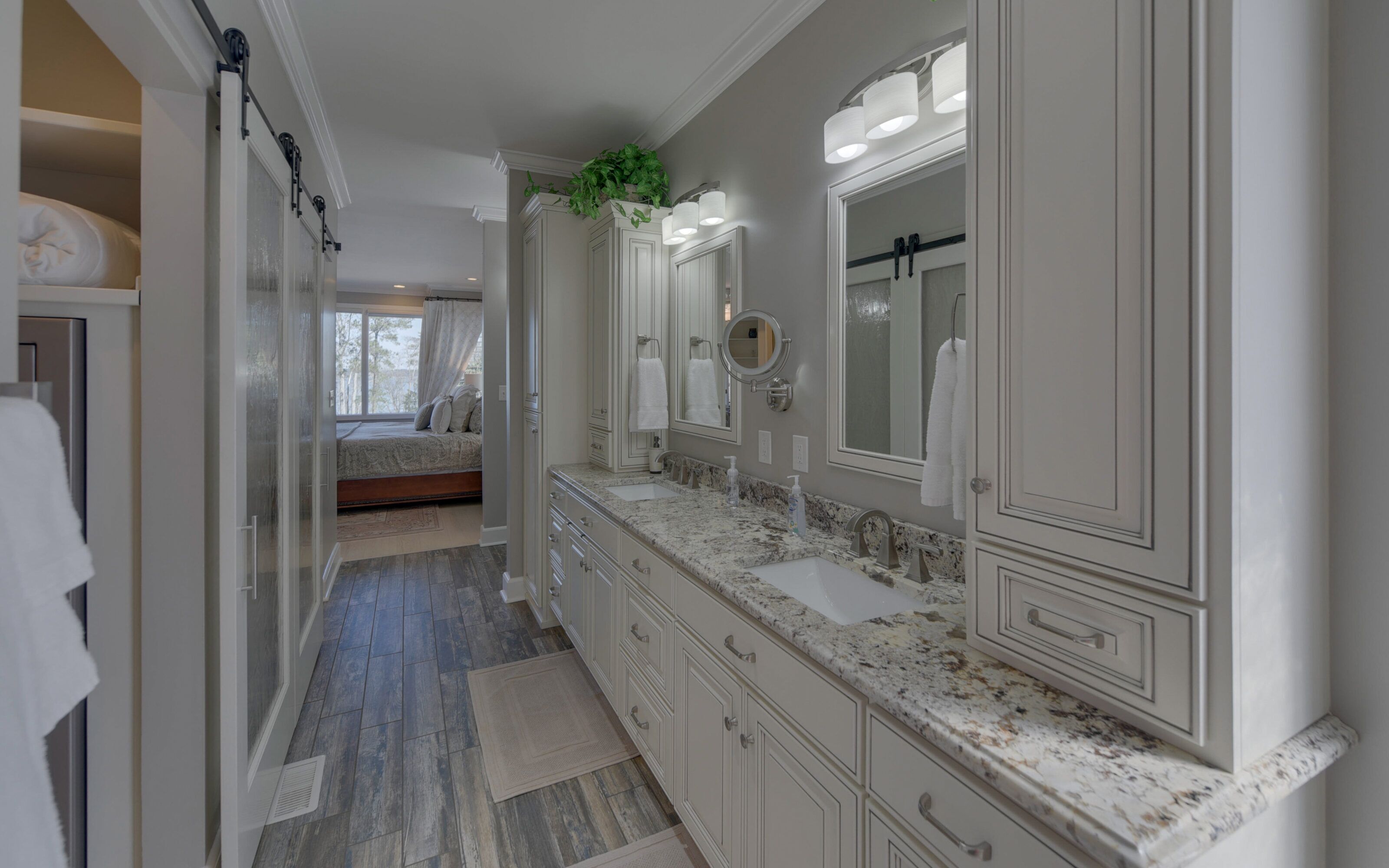 A spacious bathroom with a large vanity, multiple mirrors, and a walk-in shower.