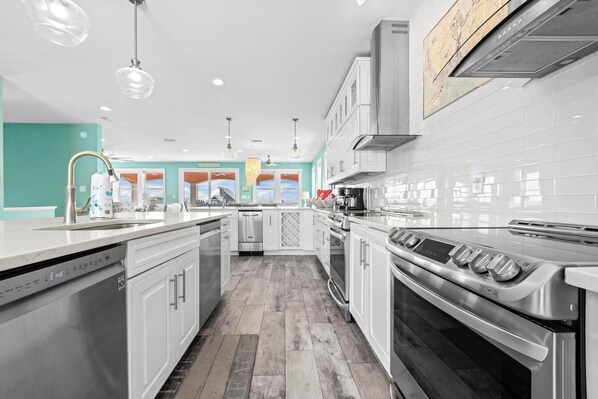 Enjoy cooking in this well-equipped kitchen with a range hood, dishwasher, and ample storage.