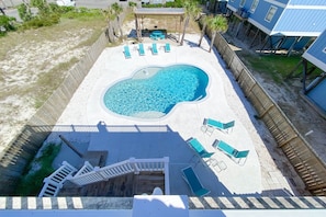 Relax by the pool surrounded by lush vegetation and modern architecture.