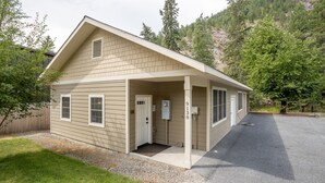 A single-story building with a covered porch, a front door, and a mailbox.