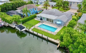 Enjoy a retreat with a dock, pool, and lush surroundings.