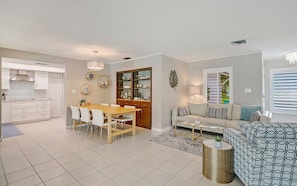 Contemporary living space with a dining area, kitchen, and comfortable seating area.