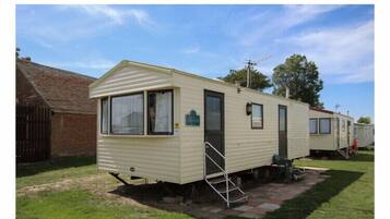 Park your home away from home in this cozy caravan, complete with a sliding door and window.