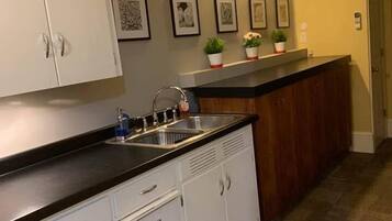 Fridge, microwave, coffee/tea maker, cookware/dishes/utensils