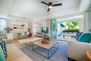 A modern living room with a sofa, coffee table, and a television.