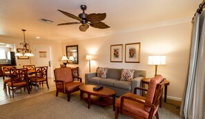 Relax in a welcoming space with a comfortable seating area, dining table, and artwork-adorned walls.