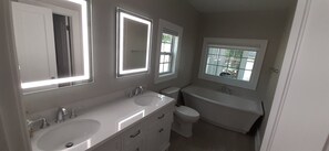 Bathtub, towels, soap, toilet paper