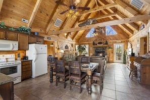Enjoy cooking in this well-equipped kitchen with a central island, sink, and seating area.