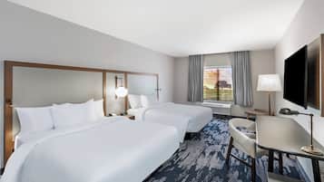 Hypo-allergenic bedding, desk, laptop workspace, blackout drapes