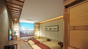 A hotel room with a large window, a bed with a red and beige bedspread, a wooden floor, and a traditional Asian-style wall panel. - Traum Valley Hotel (Jeongseon)