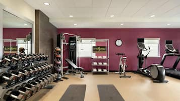 A gym with weightlifting equipment, treadmills, and exercise machines.