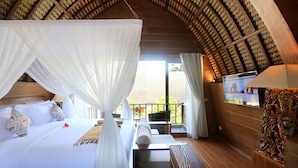 A room with a bed, a sofa, a TV, and a wooden ceiling. - Tanamas Villas Ubud (Mas)