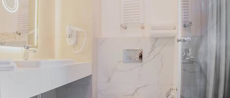 Een moderne badkamer met een witte wastafel, spiegel en toilet.