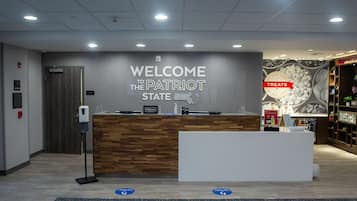 A reception desk with a sign reading "Welcome to the Patriot State."
