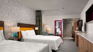 A hotel room with two beds, a desk, a TV, and a mirror. - Home2 Suites by Hilton Fishers Indianapolis Northeast, IN (Fishers)