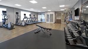 A gym with treadmills, a bench, and weight machines. - Hampton Inn Las Vegas Strip South, NV (Las Vegas)