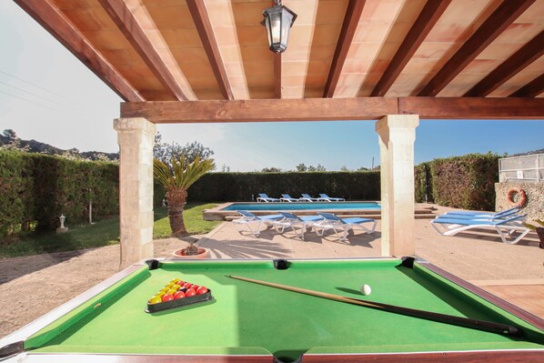 A pool table with balls, a pool cue, and a billiards rack. - LLORENS (IVANA). 5 bedroom villa to enjoy with family and friends (Pollensa)