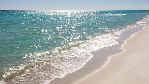 A beach with clear turquoise water and a sandy shore. - Large Private Balcony ~ Spacious Living Area (Miramar Beach)
