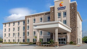 A Comfort Inn & Suites hotel with a modern design, featuring a stone facade and a covered entrance.