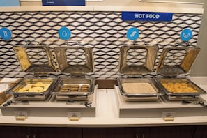 A buffet with labeled food sections including egg white & veggie omelet, turkey sausage, and sausage gravy. - Holiday Inn Express & Suites Dayton North - Vandalia by IHG (Dayton)