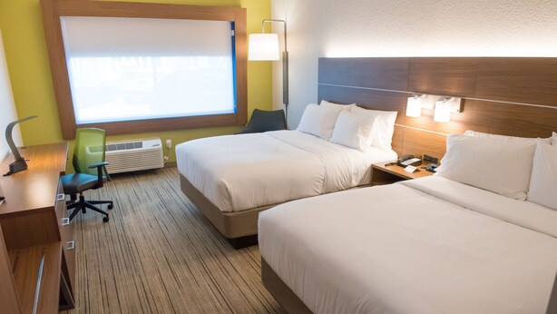 A hotel room with two beds, a desk, a chair, a lamp, and a window with blinds. - Holiday Inn Express & Suites Dayton North - Vandalia by IHG (Dayton)