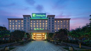 Un hôtel Holiday Inn doté d’une entrée bien éclairée et d’une grande enseigne.
