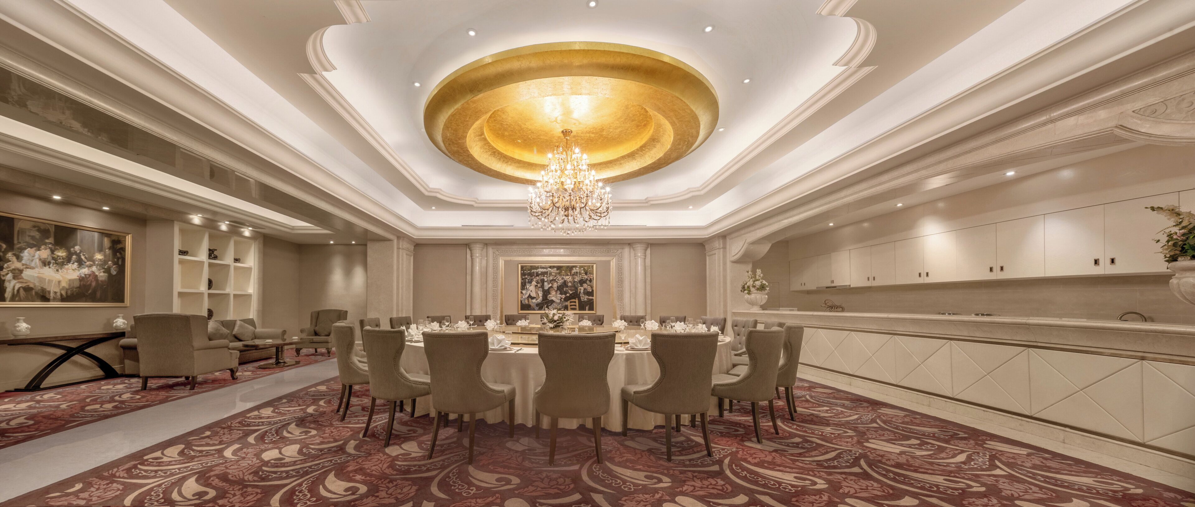 A luxurious dining room with a central chandelier, elegant chairs, and a patterned carpet.