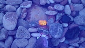 A collection of smooth, rounded pebbles in various shades of blue and gray.