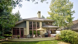 A two-story house with a covered patio, a hot tub, and a stone fireplace. - Single family remodeled platinum level home with private hot tub!! (Beaver Creek)