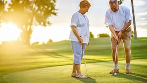 Two people playing golf on a sunny day. - 1st Floor, 2 BR, 2 Bath Sunset Beach 5 minutes to ocean @ Sea Trail Golf Resort! (Sunset Beach)